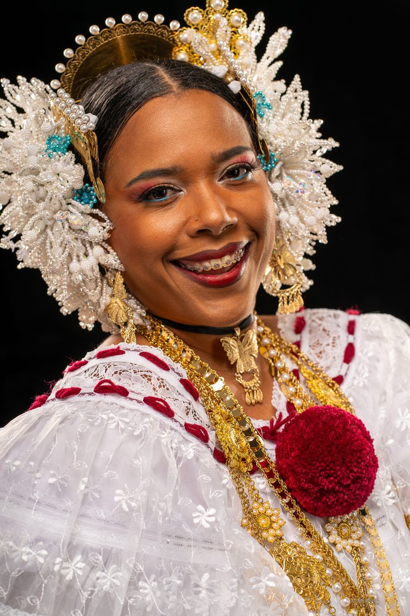 Studio portrait of a woman in a traditional pollera and beaded headdress